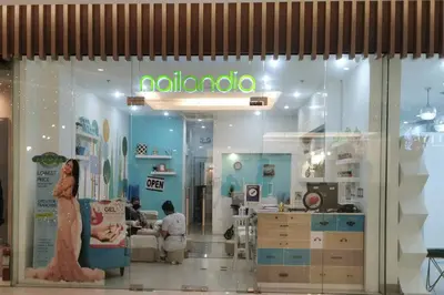 a shop window with a woman in a store at Love@Grace Residences near BGC. in Manila