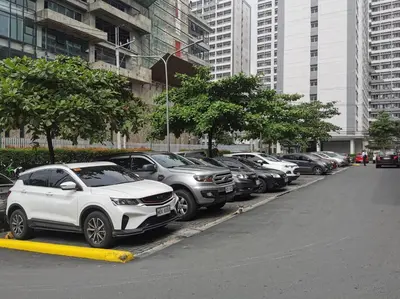 a row of cars parked in a parking lot at Love@Grace Residences near BGC. in Manila