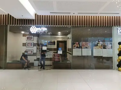 a man sitting on a couch in a store window at Love@Grace Residences near BGC. in Manila