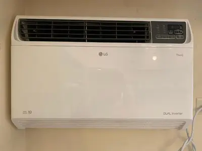 a white air conditioner sitting on a wall at Spacious condo in Venice Luxury Residences in Manila