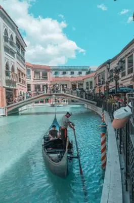 two men in a gondola on a canal in a city at Spacious condo in Venice Luxury Residences in Manila
