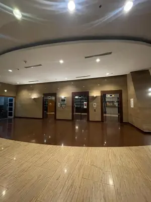 a large empty lobby with doors and a wooden floor at Pearl Of The Orient Tower, in front of US Embassy in Manila