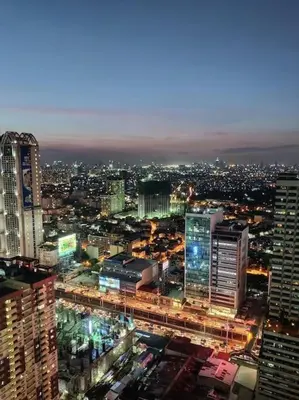 a view of a city at night with buildings at Modern Condo Apt in Flair Tower South, Mandaluyong in Manila