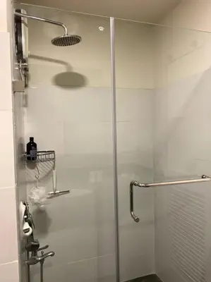 a shower with a glass door in a bathroom at Modern Condo Apt in Flair Tower South, Mandaluyong in Manila