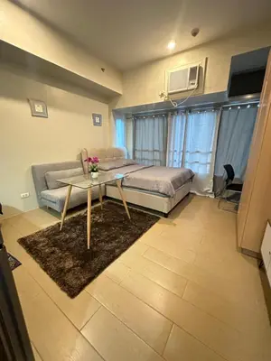 a living room with a couch and a table at EJ's Staycation 4th F with 200mbps Wi-Fi and NETFLIX in Manila