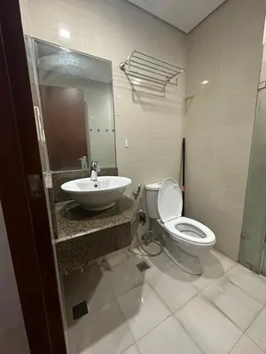 a bathroom with a toilet and a sink at EJ's Staycation 4th F with 200mbps Wi-Fi and NETFLIX in Manila