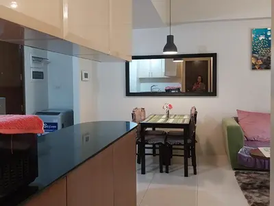 a kitchen with a table and a dining room at KENN PROPERTY in Manila