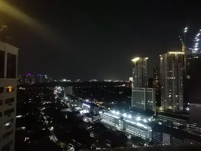 a view of a city at night with lights at accommodation service in Manila
