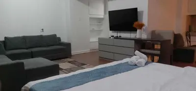 a living room with a couch and a tv at accommodation service in Manila