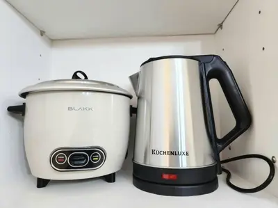 a slow cooker and a toaster sitting on a counter at BGC Fresh & Cozy Studio near Burgos Circle with Fast Internet Connection in Manila