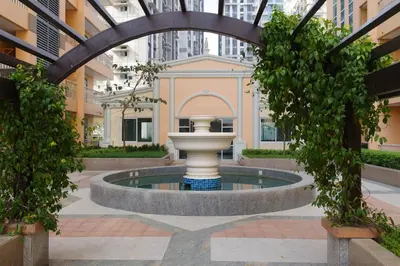 a fountain in the middle of a courtyard at Luxe in Venice in Manila