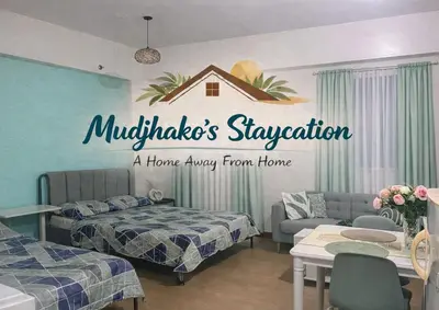 a hotel room with two beds and a sign that reads muclips sy at J & F Homestay - Cavite, Philippines in Trece Martires