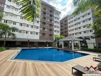 a swimming pool in front of a building at J & F Homestay - Cavite, Philippines in Trece Martires