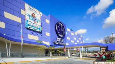 a large blue building with signs on the side of it at J & F Homestay - Cavite, Philippines in Trece Martires