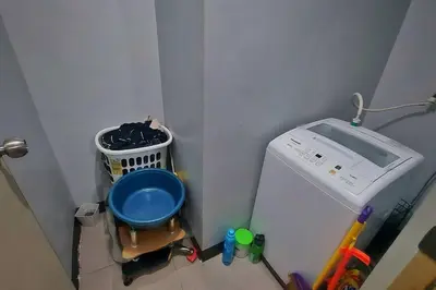a corner of a room with a washing machine at 1 Br Near Naia T3/Resorts World in Manila