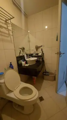 a bathroom with a toilet and a sink at 1 Br Near Naia T3/Resorts World in Manila