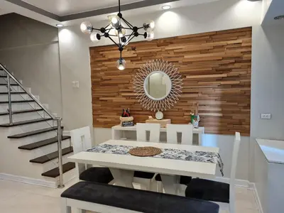 a dining room with a table and a mirror at Huge condo unit near Burgos Circle, St Lukes, Shangri-La - P Hamptons T1 in Manila