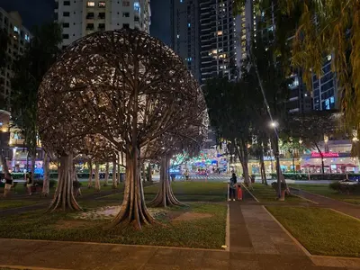 a sculpture of a tree in a park at night at Huge condo unit near Burgos Circle, St Lukes, Shangri-La - P Hamptons T1 in Manila