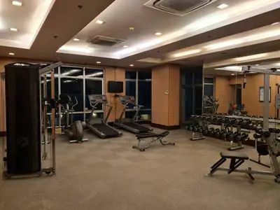 a gym with a lot of equipment in a room at Huge condo unit near Burgos Circle, St Lukes, Shangri-La - P Hamptons T1 in Manila