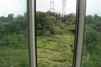 a window with a view of a field of grass at Casa Antonio at Stamford McKinley Hill Unli Wi-Fi Near Piazza in Manila