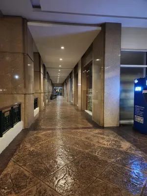 an empty hallway of a building with a tile floor at Casa Antonio at Stamford McKinley Hill Unli Wi-Fi Near Piazza in Manila