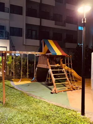 a playground with a tent in a park at night at Condominium at Spring Residences near Airport in Manila