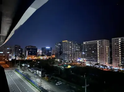 a city skyline at night with buildings and traffic at Hygge Suite @ Moa complex near Naia, Ccp , Dfa in Manila
