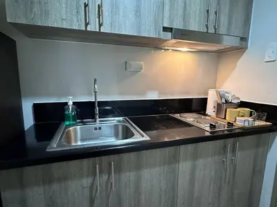 a kitchen with a sink and a counter top at Hygge Suite @ Moa complex near Naia, Ccp , Dfa in Manila