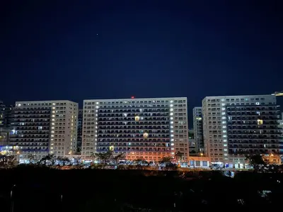 a group of tall buildings in a city at night at Hygge Suite @ Moa complex near Naia, Ccp , Dfa in Manila
