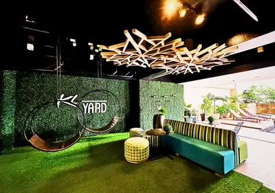 a room with a couch and tennis rackets on a wall at KL Tower Makati near Greenbelt with free access to gym, sauna & 100Mbps Wi-fi in Manila