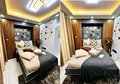 a bedroom with two beds and a wall with clocks at KL Tower Makati near Greenbelt with free access to gym, sauna & 100Mbps Wi-fi in Manila