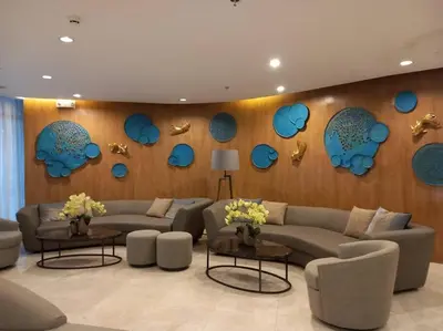 a living room with couches and blue decorations on the wall at Shore 2 Condo unit near MOA in Manila