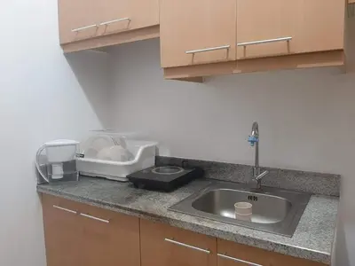 a kitchen counter top with a sink and a sink U No No Nohibahiba at Male Bunkbed Room Sharing in Manila
