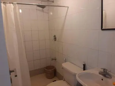 a white bathroom with a toilet and a sink at Male Bunkbed Room Sharing in Manila