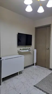 a living room with a flat screen tv on a wall at Larue cozy room in Solemare Parksuites Paranaque in Manila