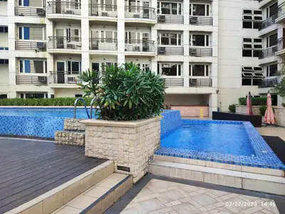 a swimming pool in front of a building at Larue cozy room in Solemare Parksuites Paranaque in Manila