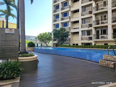 a swimming pool in front of a building at Larue cozy room in Solemare Parksuites Paranaque in Manila
