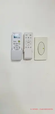 two remote controls sitting next to each other on a table at EJ Homes - Fame Residences in Manila