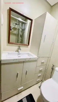 a bathroom with a sink and a mirror at EJ Homes - Fame Residences in Manila