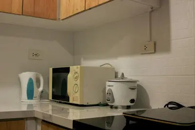 a microwave sitting on top of a kitchen counter at Serenity Suites: Your tranquil gateway! in Biñan