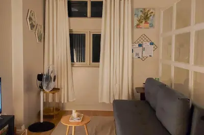 a living room with a couch and a window at Serenity Suites: Your tranquil gateway! in Biñan