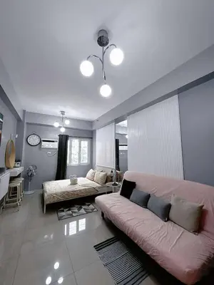 a living room with a couch and a table at Homestay Manila Mall of Asia Shore Residences at TresMarias' in Manila