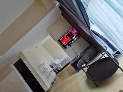 an overhead view of a living room with a chair at Caleze Properties AVANT at the Fort BGC Studio in Manila