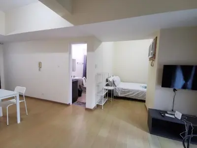a living room with a television and a bedroom at Caleze Properties AVANT at the Fort BGC Studio in Manila