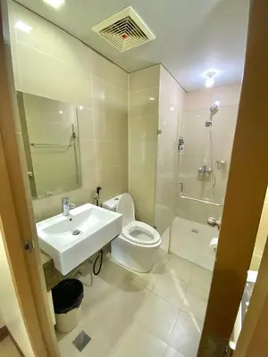 a bathroom with a sink and a toilet and a shower at Condo in Newport City Pasay near NAIA T3 AIRPORT MANILA in Manila