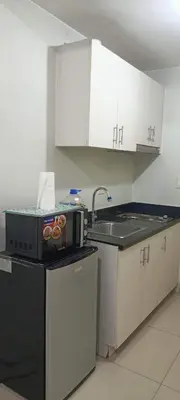 a kitchen with a sink and a counter top at Jazz Residences Makati City by darpm in Manila