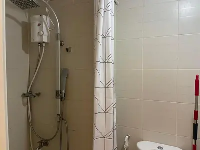 a shower in a bathroom with a white shower curtain at Jazz Residences Makati City by darpm in Manila