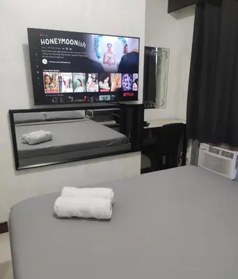 a white towel sitting on top of a bed in a room at Citadel Inn in Manila
