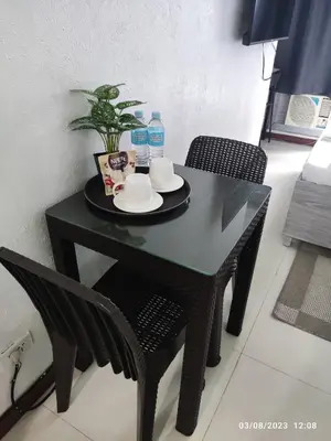 a black table with two chairs and two bottles of water at Citadel Inn in Manila