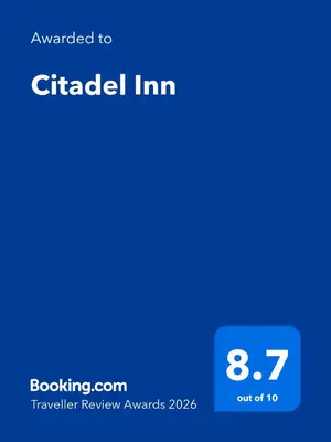 a screenshot of a cell phone with the upgraded to circled inn at Citadel Inn in Manila